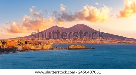 beautiful panorama of volcano Vesuveus from Naples with blue water of sea gulf, majectic mountain and amazing cloudy sunset sky on background Royalty-Free Stock Photo #2450487051