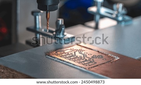 machine with numerical control CNC carries out milling of printed circuit boards, Circuit Engraving, Diy Circuit Boards PCB Royalty-Free Stock Photo #2450498873