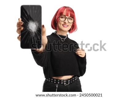 Young female with red hair holding a smartphone with a broken screen isolated on white background