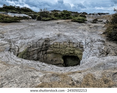 Dips in the soil, releases of sulfur gases, volcanic activity, zone of geothermal activity in the Rotorua region North Island of New Zealand Royalty-Free Stock Photo #2450502213