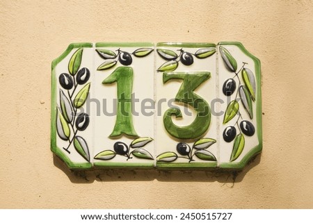 Close up view of ceramic address plate with number 13
