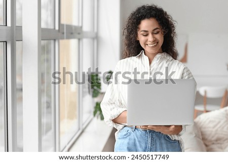 Young African-American woman using laptop at home