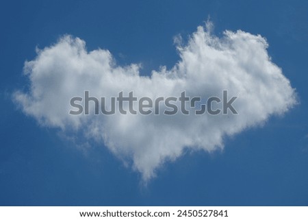 white clouds like the shape of the Love symbol. Unique clouds formed in the blue sky due to the influence of the wind. Abstract shapes and patterns for graphic design backgrounds