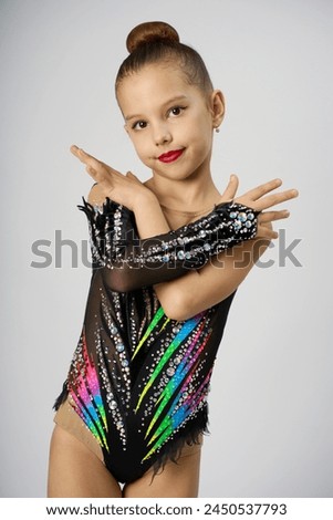 Portrait of a rhythmic gymnastics artist on a white background. Young beautiful sportive girl.