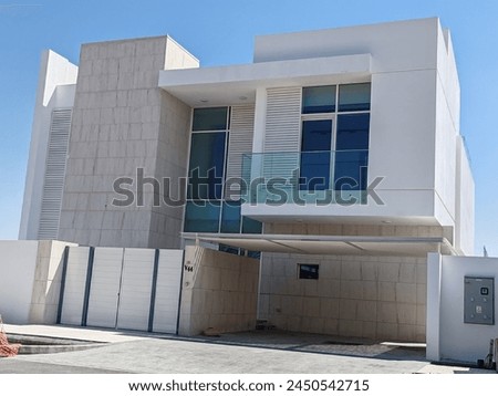 House or Vvilla's, Villa's with Cream color, Exterior view of 02 story house with modern design and having black glass windows.
Exterior view of modern style Residential Villa's or Houses for living. 