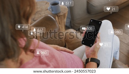 Image of social media icons with growing numbers over caucasian woman using smartphone. Social media, communication and digital interface concept digitally generated image.