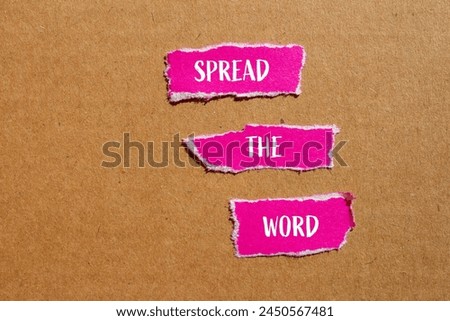 Spread the word written on ripped pink paper pieces with cardboard background. Conceptual spread the word symbol. Copy space.