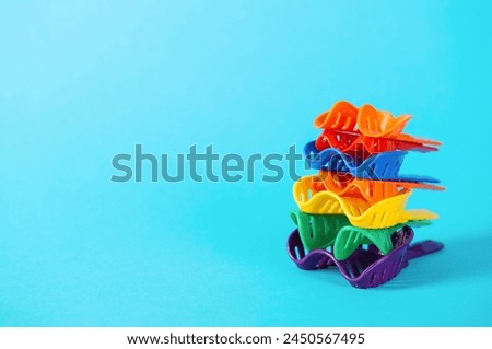 Multi-colored dental spoons for taking an impression of the dental jaw on a blue background. Making an impression of the jaw for braces and dental prosthetics. Royalty-Free Stock Photo #2450567495