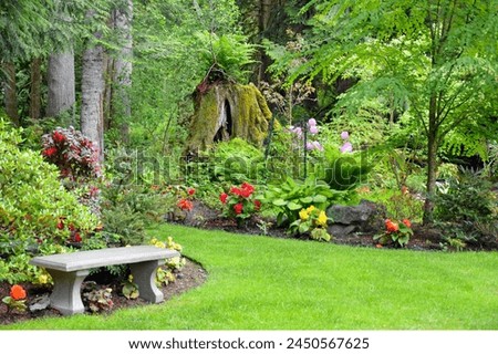 Greenery garden with colorful flowers, trees Royalty-Free Stock Photo #2450567625