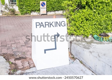 Valet parking sign at the entrance to a restaurant,white valet parking only sign on a close up view,Empty parking lot area,Template,Copy text space.
