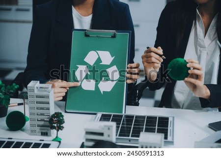 Carbon offset price report CO2 emission. Future growth Net zero waste in ESG ethical SME office protect climate change global warming social issues project. Group of asia people Eco friendly SDGs plan Royalty-Free Stock Photo #2450591313