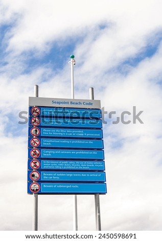 Beach rules at Seapoint in Dublin with clouds and sky in the background Royalty-Free Stock Photo #2450598691