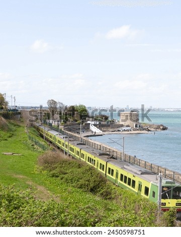 Train on a sceninc route around Seapoint beach in Ireland next to the sea Royalty-Free Stock Photo #2450598751