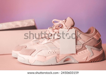 Stylish pair of women's sneakers with a label, a place for your logo.