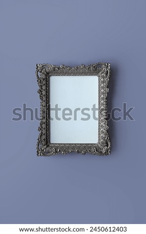 Vintage silver picture frame on purple background.; openwork metal frame, empty picture frame mockup