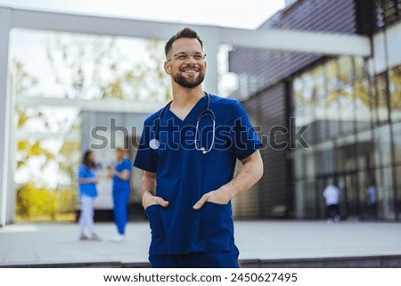 Portrait of a young medical practitioner standing with his arms crossed in a hospital. Happy in his Profession. Male nurse with stethoscope standing at clinic. 