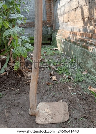 A hoe is a traditional tool for hoeing soil. In Indonesia called cangkul. Royalty-Free Stock Photo #2450641443