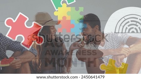 Image of colourful puzzle pieces and autism text over happy friends at summer beach party. autism, learning difficulties, support and awareness concept digitally generated image. Royalty-Free Stock Photo #2450641479