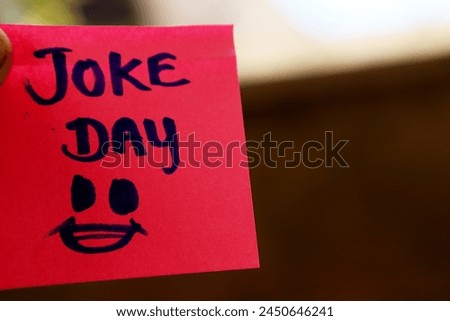Joke day sticky note concept in red and brown colours