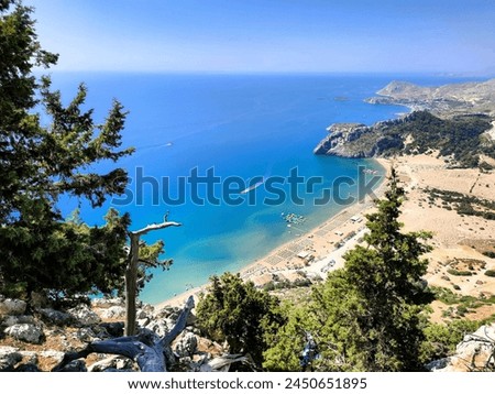 Tsambika beach with golden sand on the island of Rhodes in Greece. Taken from a high rock above the beach. A wonderful view of the entire beach. Royalty-Free Stock Photo #2450651895