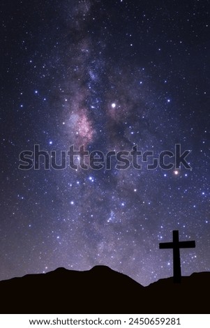 Cross silhouette on mountain with milky way galaxy, Night starry sky with stars 