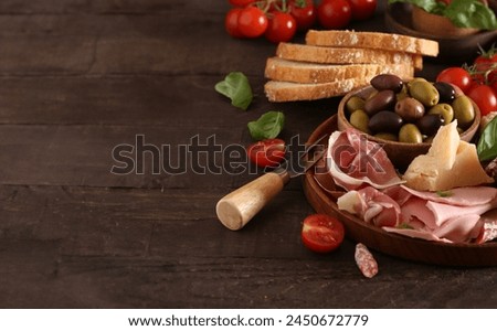 antipasti tapas with cheese and ham on wooden table