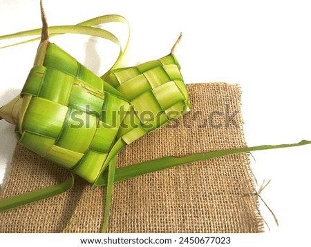 Photo of a ketupat or diamond on a brown cloth with a white background