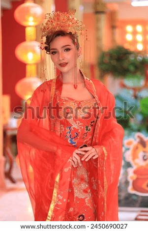 Portrait of beautiful asian woman in red chinese dress traditional cheongsam. chinese new year concept. Cheerful girl in red cheongsam. 