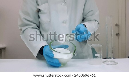 Pharmacist elaborating  a white ointment in a mortar in the pharmacy laboratory Royalty-Free Stock Photo #2450696761
