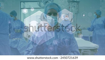 Image of medical icons over diverse surgeons. global medicine, healthcare and technology concept digitally generated image.