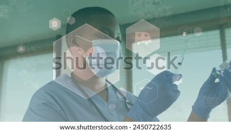 Image of medical icons over african american female doctor wearing face mask. global medicine, healthcare and technology during covid 19 pandemic concept digitally generated image.