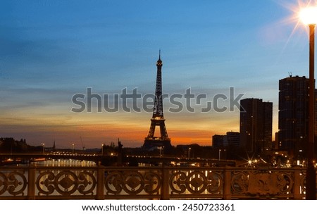 View of Eiffel Tower and river Seine at sunset in Paris, France. Eiffel Tower is one of the most iconic landmarks of Paris