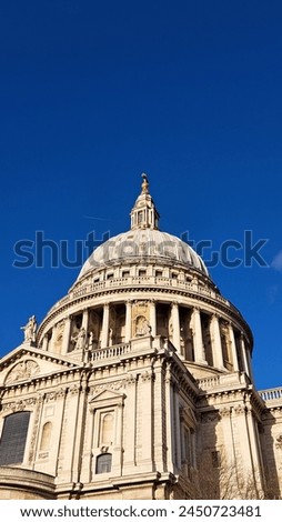 A captivating close-up image of the intricate architecture of St. Paul's Cathedral in London against a clear blue sky.
