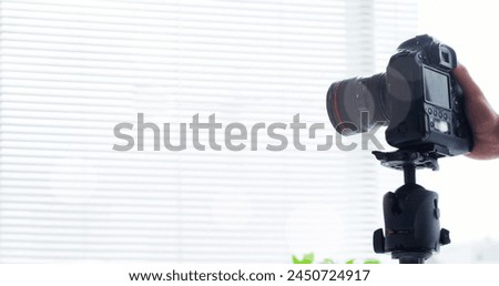 White spots floating against mid section of a man placing a digital camera on a tripod. world photo day awareness concept