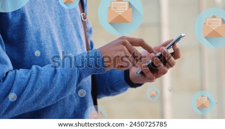 Image of mail icons over midsection of biracial man using smartphone. global connections, social media, technology and digital interface concept digitally generated image.