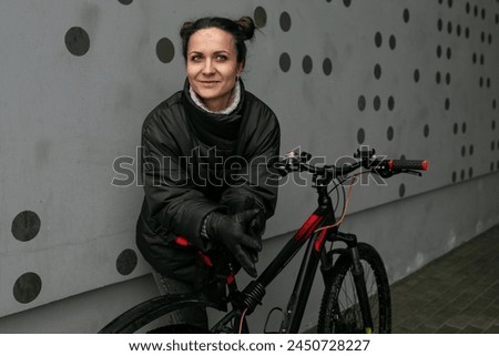 Young pretty woman riding a bicycle in winter