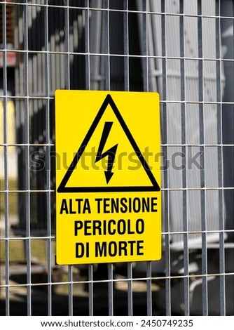 large danger sign of a power station with the writing in Italian HIGH VOLTAGE DANGER OF DEATH