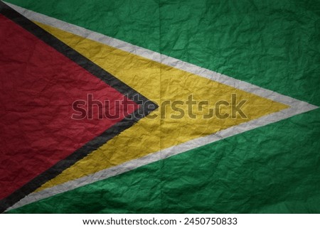 colorful big national flag of guyana on a grunge old paper texture background
