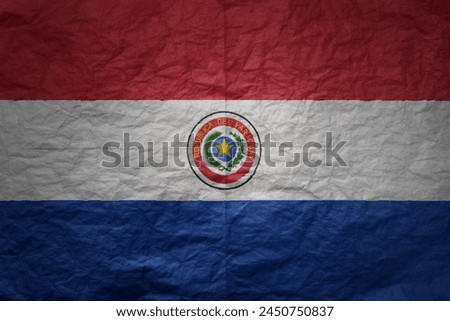 colorful big national flag of paraguay on a grunge old paper texture background