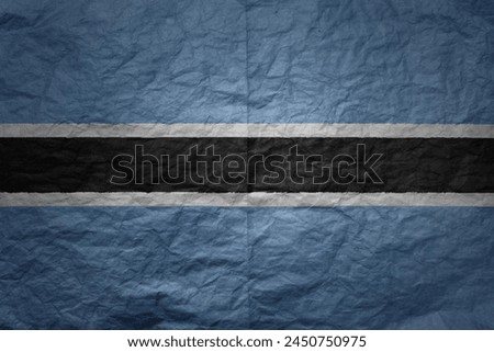 colorful big national flag of botswana on a grunge old paper texture background