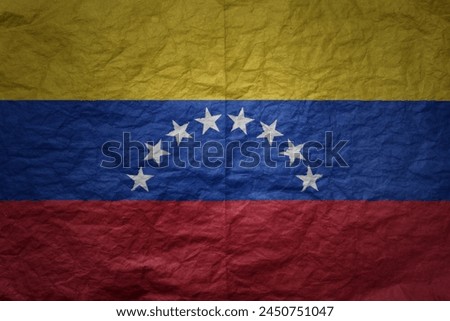 colorful big national flag of venezuela on a grunge old paper texture background