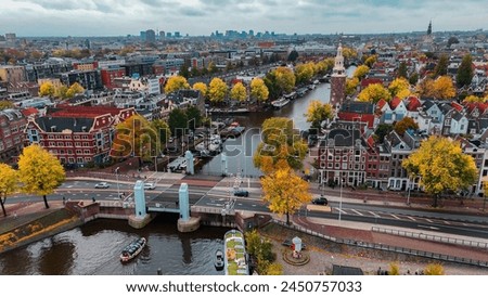 Aerial drone view Amsterdam autumn cityscape narrow old houses, canals, boats bird's eye view. 