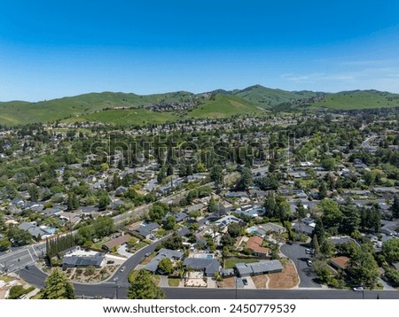 Drone photos of the beautiful landscape of Clayton, California with blue skies, green hills and houses