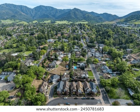 Drone photos over the landscape of Clayton, California with blue skies and green hills.