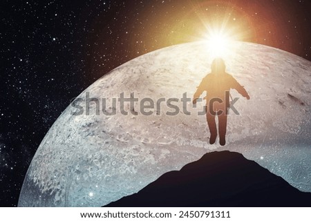 Silhouette of an astronaut levitating against the background of the planet. Elements of this image courtesy of NASA.