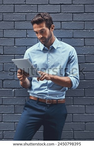 Business man, tablet and web research, reading email or info online on a wall background in city. Serious, digital tech and professional scroll on app, typing and salesman networking on internet