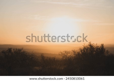Horizontal picture of a beautiful sunset in South Africa during a game drive. Warm hues during a South African sunset. 