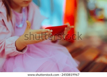 
Child Using a Smartphone at the Playground instead of Playing 
Toddler girl being captivated and binging a cartoon show outdoors
