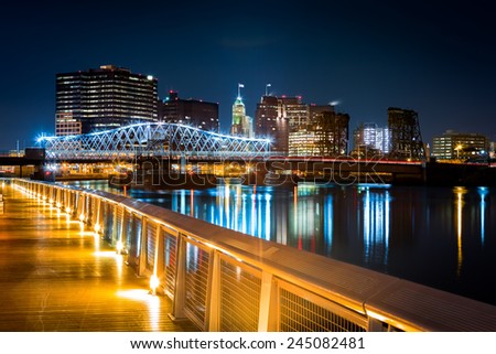 Newark, NJ cityscape by night, viewed from Riverbank park. Jackson street bridge, illuminated, spans the Passaic River Royalty-Free Stock Photo #245082481