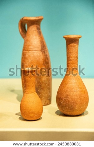 Antique ceramic decorative amphora on a white background. Clay jugs and a pot, a set of ancient utensils for drinking wine, water or milk. High quality photo